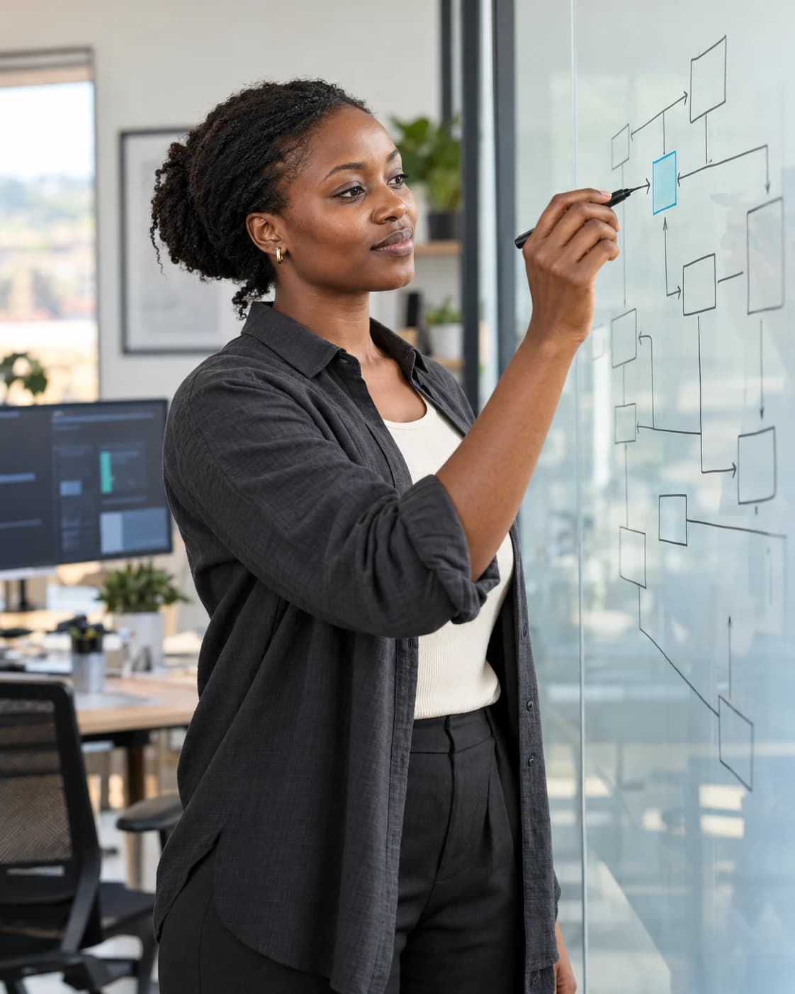 Software architect designing a system on a glass board